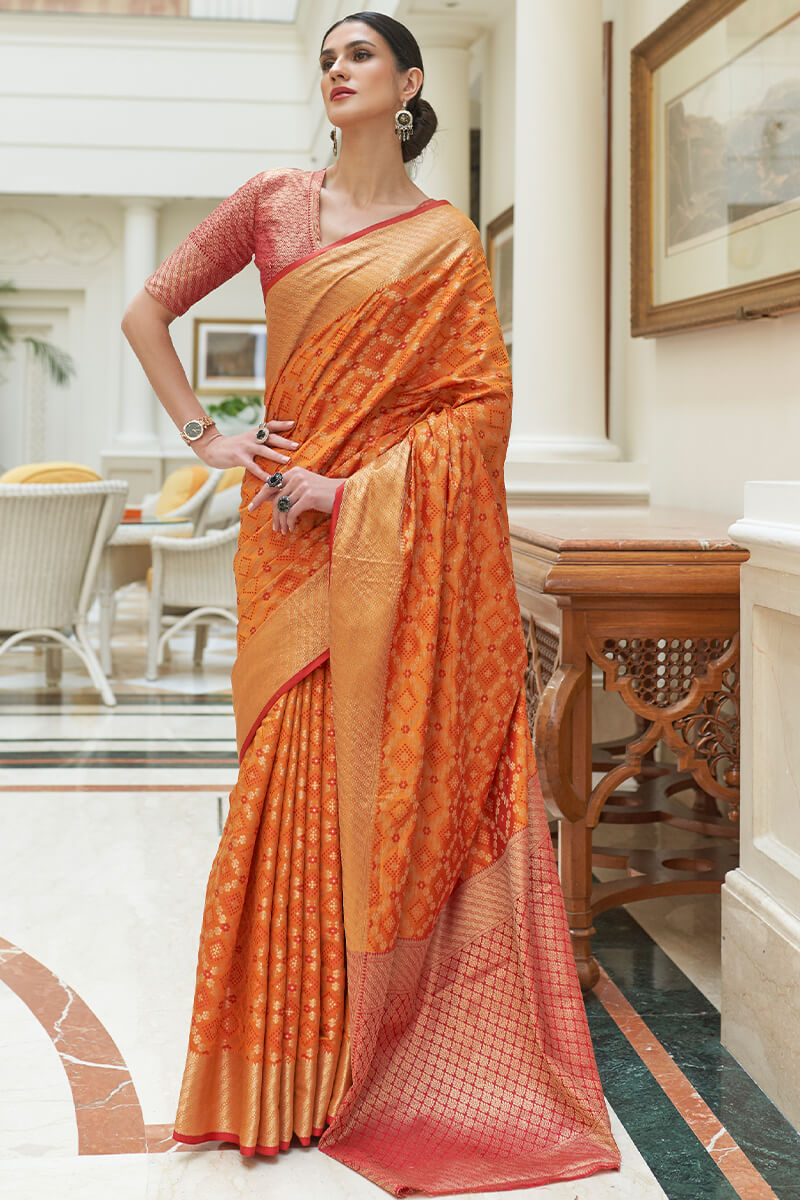 Arresting Orange Soft Patola Silk Saree with Entrancing Blouse Piece