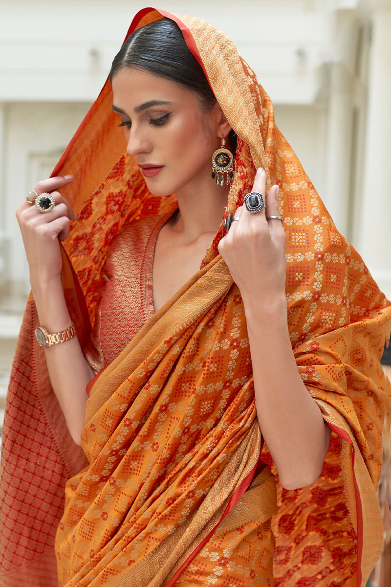 Arresting Orange Soft Patola Silk Saree with Entrancing Blouse Piece